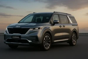 Kia Carnival 2025 premium MPV in metallic grey parked at sunset showing SUV-inspired front design, LED headlamps, and upscale exterior profile.