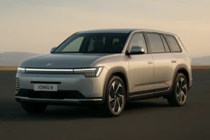Hyundai Ioniq 9 full-size electric SUV in silver, parked on an open road with soft sunset lighting, showcasing its pixel LED headlights, aerodynamic design, and premium EV stance.