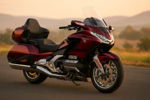 Honda Gold Wing 2026 luxury touring bike in metallic red parked on an open road during sunset, showcasing its premium design, 1833cc flat-six engine and touring comfort.